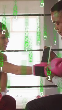 Vertical video: Boxer reaching coach fitting pink mitt locking strap training; green binary falling