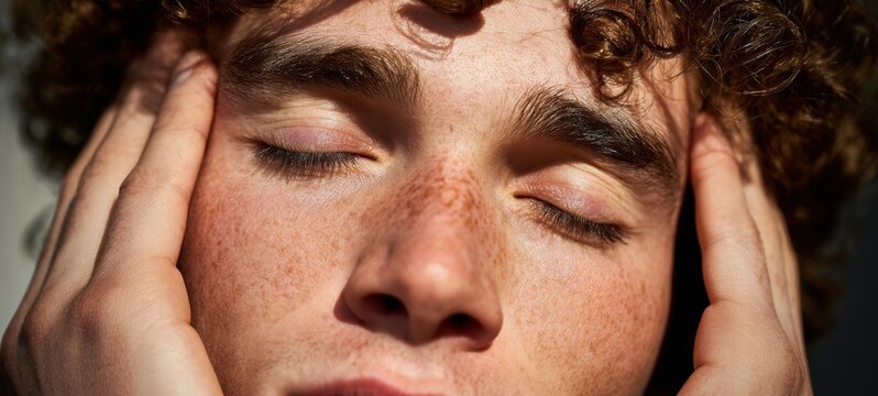 Man with hand on head, deep in thought.