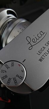 Jakarta, Indonesia - 3 March 2026: Close-up detail of a classic silver Leica rangefinder camera with mounted 35mm lens, showing aperture and focus rings. Premium vintage photography equipment with ico