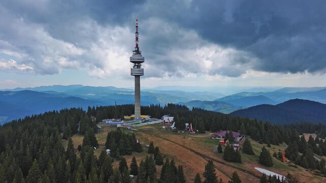 Tower Snezhana on peak of Snezhana covered with spruce forests in Rhodope mountains