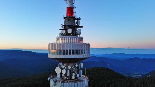 Tower Snezhana on peak of Snezhana covered with spruce forests in Rhodope mountains