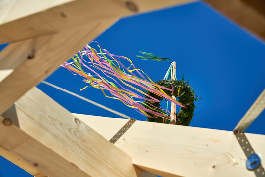 Traditional German Topping-Out Ceremony Wreath with Ribbons Against Blue Sky