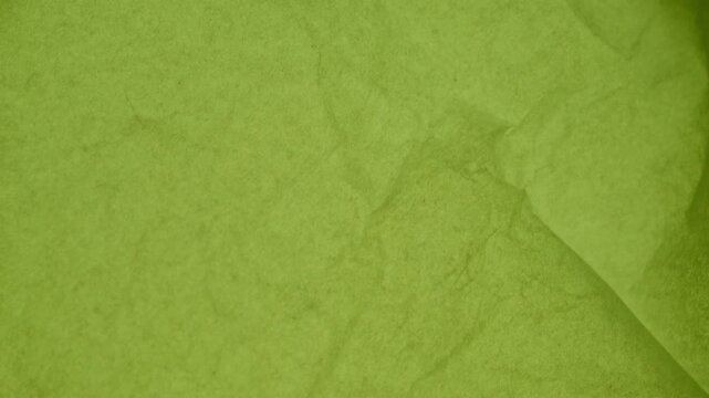 A vintage green paper texture background with an aged grunge pattern on a rough antique parchment surface