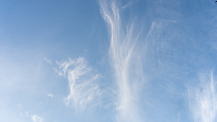 Whispy White Cirrus Clouds on Bright Blue Sky - Minimalist Background