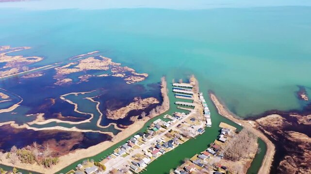 Aerial drone view of Long Point Provincial Park lakeshore with Canada geese and coastal wetlands along Lake Erie, Ontario Canada &ndash; 22 April 2026 scenic North American wildlife landscape cinematic 4K.