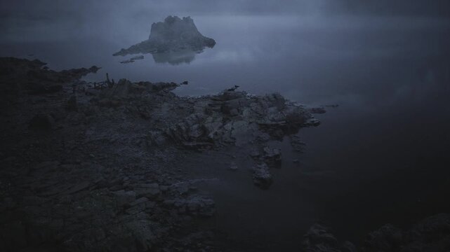 Small rocky islet isolated in shallow dark tide, isolated silhouette surrounded by textured flats, shallow channels and shadowed water emphasize remoteness,