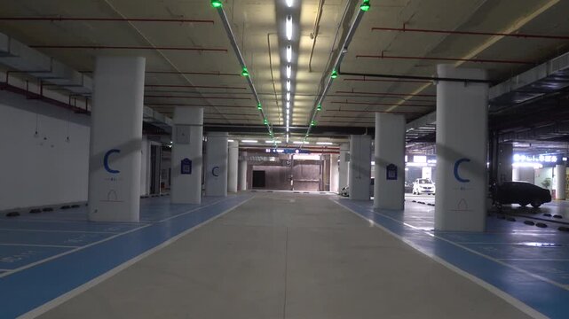 Empty Underground Parking Garage with LED Lighting and Concrete Floor