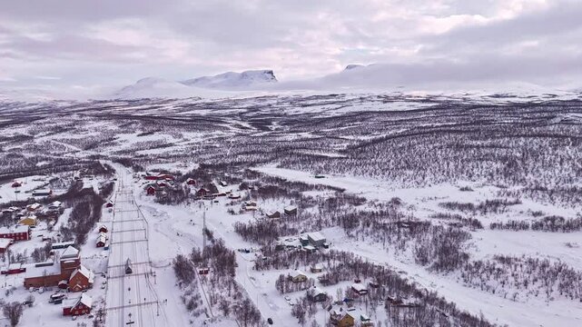 Timelapse of Abisko train station and village, in winter, with the famous Lapporten mountains in the distance, Sweden.