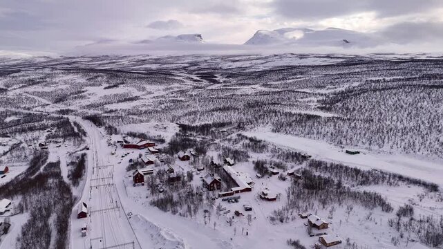 Abisko train station and village, in winter, with the famous Lapporten mountains in the distance, Sweden.