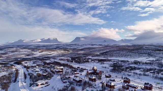 Abisko train station and village, in winter, with the famous Lapporten mountains in the distance, Sweden.