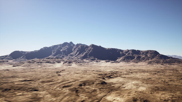 arid desert plain with distant mountains, cracked earth and sparse scrub under clear blue sky, warm midday sunlight highlighting rocky ridges and plateau