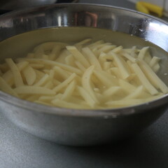 hand cut fries in a bowl with water 
