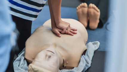 Learning CPR techniques for first aid on a resuscitation mannequin during training