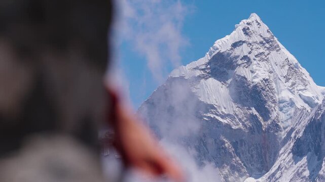 Stunning view of the iconic snow-covered Ama Dablam peak in Nepal, beautifully framed by colorful Tibetan prayer flags
