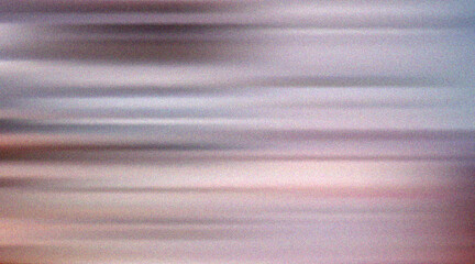 Abstract horizontal motion blur with soft pastel colors and subtle grain.
