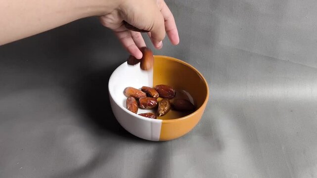 Pouring Brown Date Fruits Into White Bowl Video