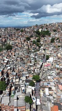 Aerial drone view of Favela Of Cantagalo, Rocinha favelas spread out on the mountain in Sao Conrado , Rio de Janeiro, Brazil.