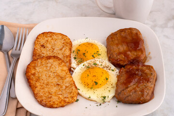 frried eggs  with salisbury steak and hash browns