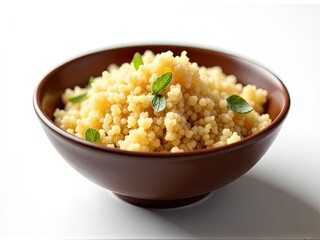 A serving of couscous on a clean white surface, ready for consumption