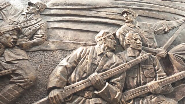 Close-up relief sculpture of revolutionary soldiers