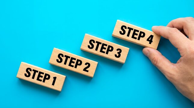 Four wooden blocks labeled Step 1 Step 2 Step 3 and Step 4 are arranged in a staircase formation on a bright blue surface progress sequence planning strategy business success