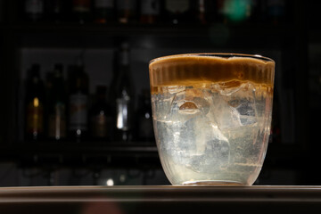 Chilled espresso cascades over icy cubes as whispers of Hygge and International Coffee Day waft through the air © fotoworld