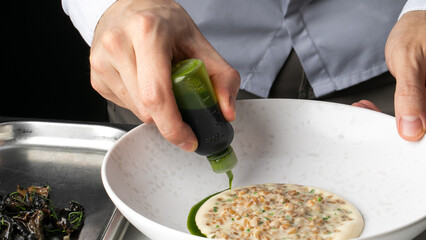 Crafting culinary magic, East Asian male chef drizzles verdant elixir, a dance of umami, tempura...