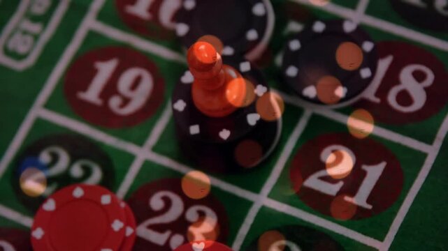 Animation of spots of light over close up of a stack of casino poker chips on a table