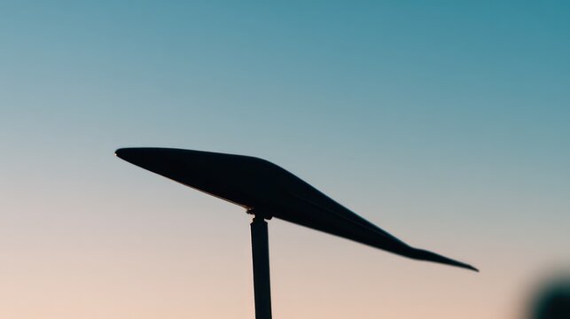 Minimalist silhouette of a monoplane with a single wing against a gradient sky. mobility guides, transit brochures, designed for transport & logistics marketing.