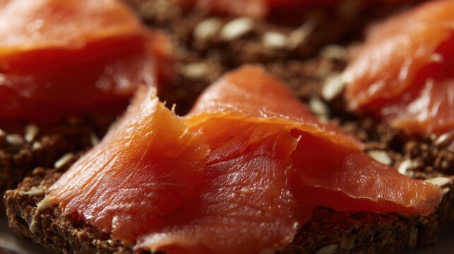 Close-up of oily smoked salmon slices on dark rye bread. menu design, packaging mockups, designed for culinary blogs and recipe cards for restaurants, used by interior designers.