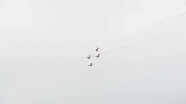 The Strizhi aerobatic team performs aerobatic maneuvers on MiG-29s against the backdrop of a gray autumn sky