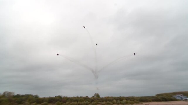 The Strizhi aerobatic team performs aerobatic maneuvers on MiG-29s against the backdrop of a gray autumn sky