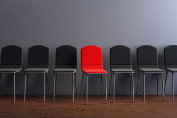 Obraz premium Row of dark chairs with one red standout seat symbolizing uniqueness, selection, and business choice in a modern corporate interior environment. 3D Rendering