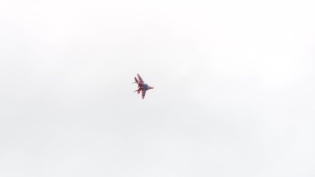 The Strizhi aerobatic team performs aerobatic maneuvers on MiG-29s against the backdrop of a gray autumn sky