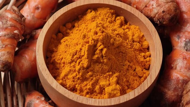 Close-up video of turmeric powder in a wooden bowl	