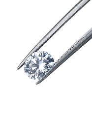 Fototapeta premium A sparkling, round-cut gemstone held delicately by silver tweezers against a bright white background, showcasing its brilliance