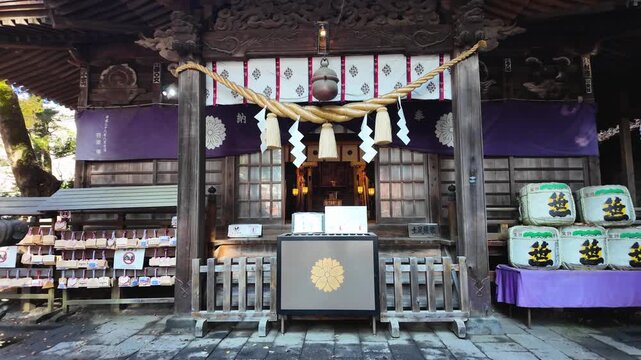 Traditional Shinto Shrine Framed by Vibrant Autumn Foliage in Japan