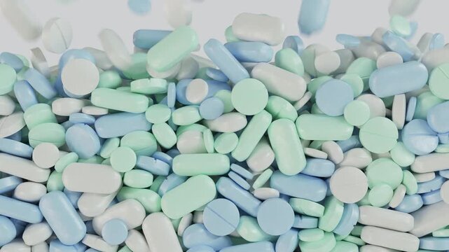Medical pills or vitamins in pastel blue, green, and white fall to fill the screen in an alpha transition. Daily health routines, medical lawsuits, and overmedication concepts.