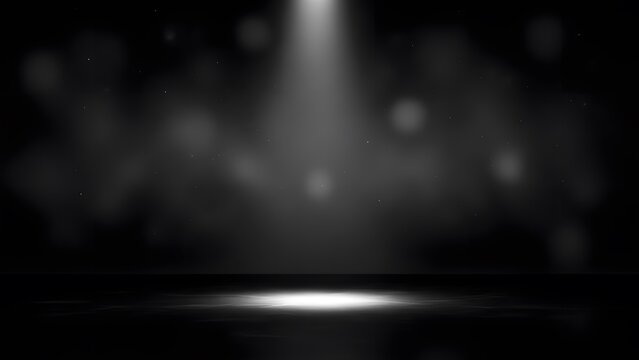 A spotlight shines down on a dark stage with a beam of light