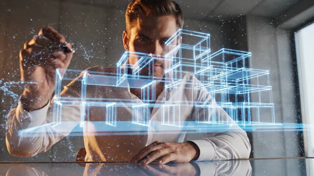 Male architect in white shirt sketches 3D building designs with digital pen on glass surface, illuminated by bright blue holographic projections in modern office