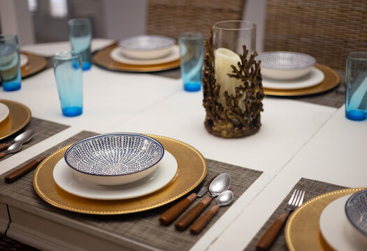 Closeup dining table settings with coral decor and a tropical feel