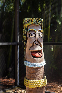 Tiki totem pole with smiling face in enclosed patio screen