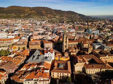 Epic Spanish gothic city panorama. 
Cinematic aerial view of 
San Salvador Cathedral and 
orange roofs in Oviedo, 
Asturias, Spain.
