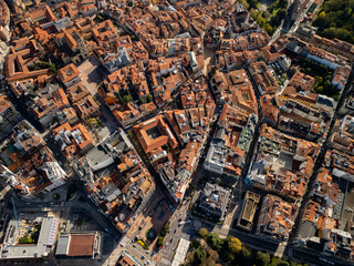 High altitude aerial view of Oviedo old town with terracotta orange roofs, bird's eye perspective of the historic city center in Asturias, Spain, 4K drone