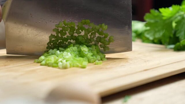 Chopped Celery on Wooden Cutting Board with Knife