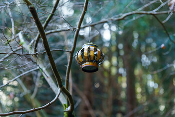 木の枝に吊るされた小さな灯籠