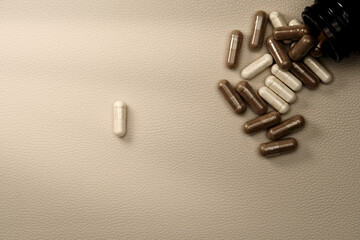 Fototapeta premium Supplements capsules spilling from bottle representing healthcare
