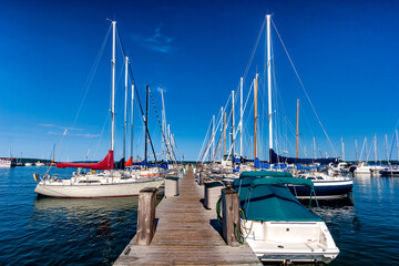 Fototapeta premium Sailboats moored in a marina under a clear blue sky