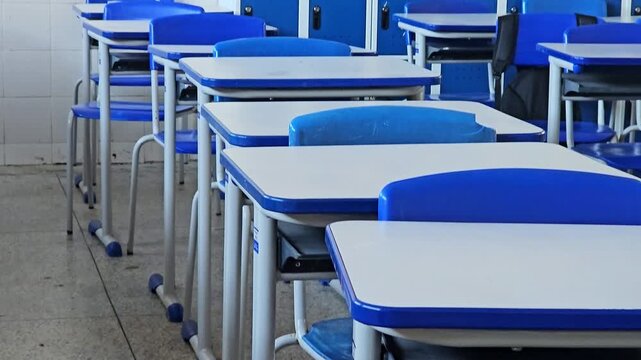 An empty classroom with chairs and cabinets, ready to receive the students.