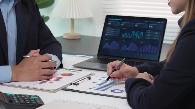 Business people analyzing financial data and charts during a strategy meeting in the office